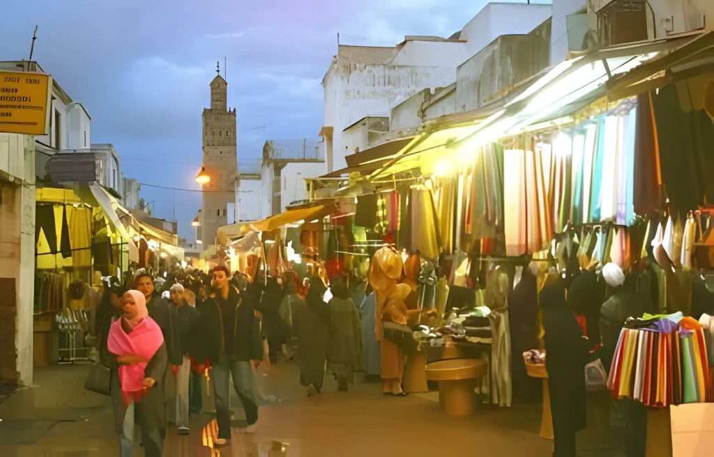 Street with souks and shops with mosque at dusk market kenitra morocco marocmaker