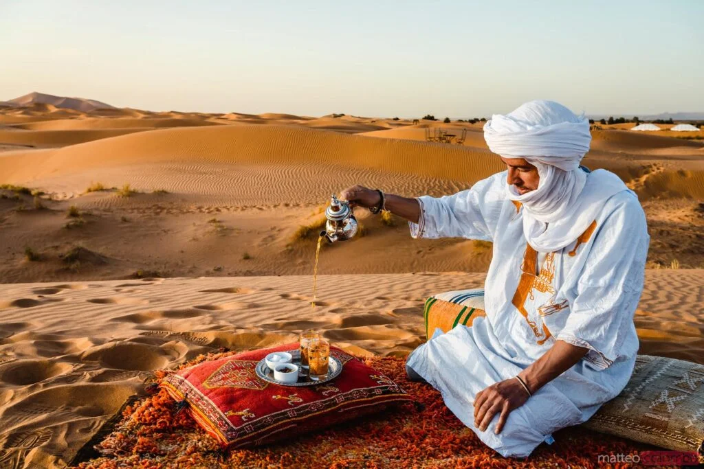 Berber man serving tea in the desert, Morocco